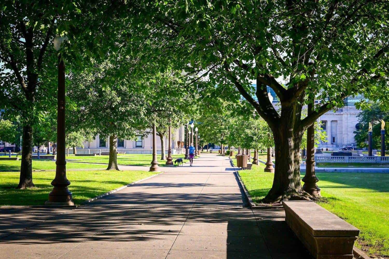 A view of Indianapolis and a person walking on the path during the daytime.