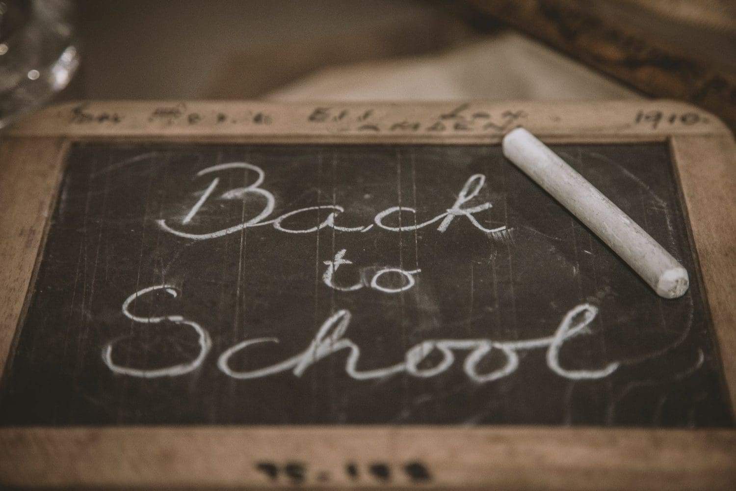 A black slate and 'Back to school' text written on it.