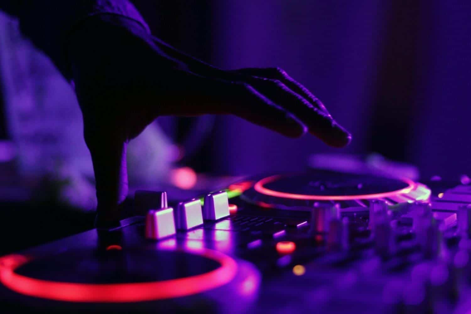 A close-up of the Disc Jockey played in the neon lights.