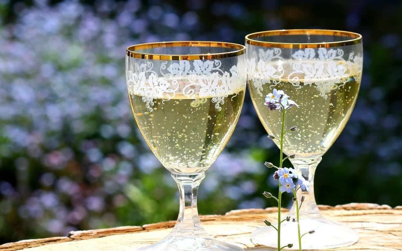 Two decorated wine glasses of sparkling wine.