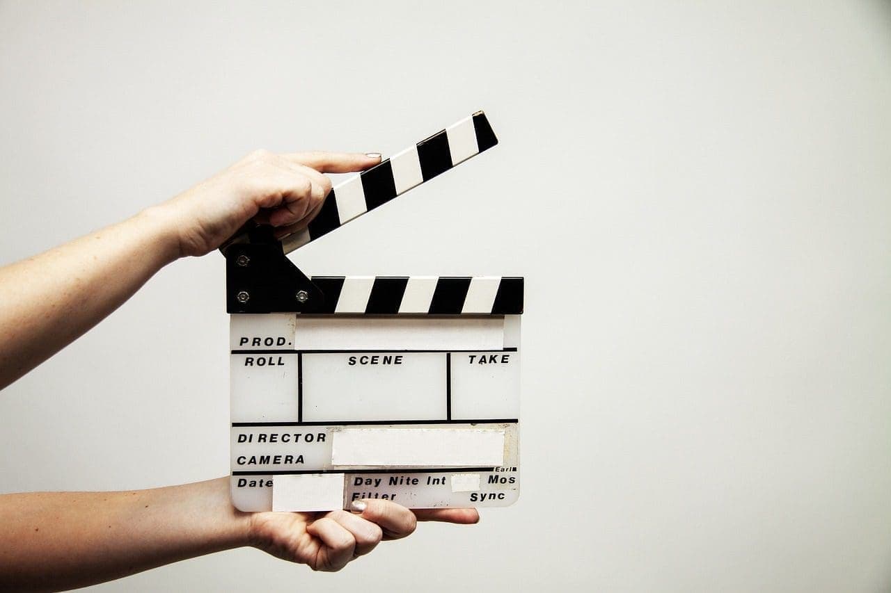 A view of a person holding a clapboard.