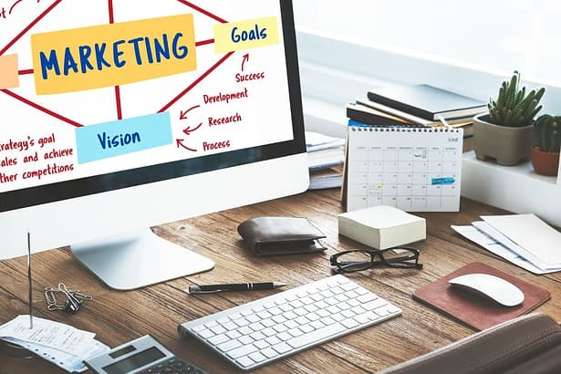 Marketing strategy planning on computer screen in office setup.